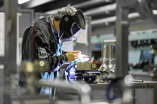 Man with Welding Mask working on Small Electrical Component